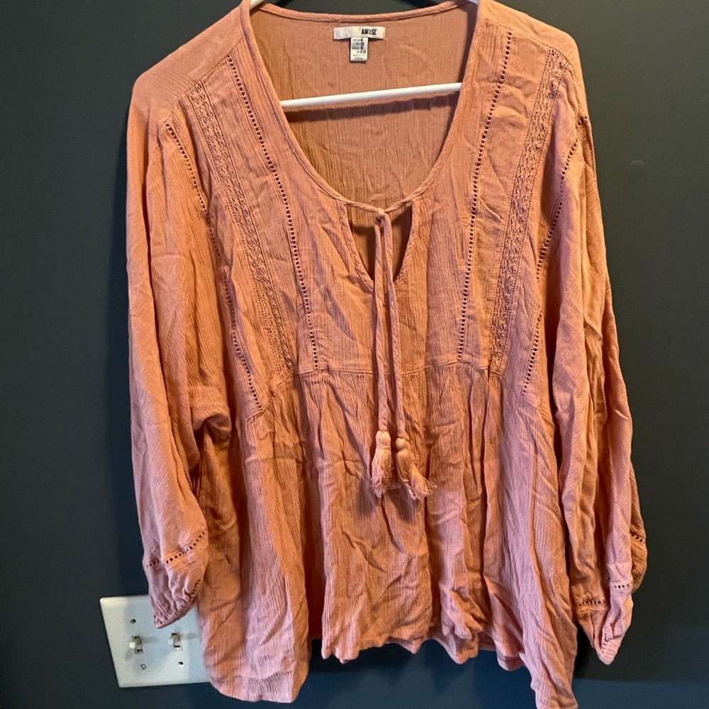 Soft flowy peachy blouse nice detail and drawstring neckline.medium size